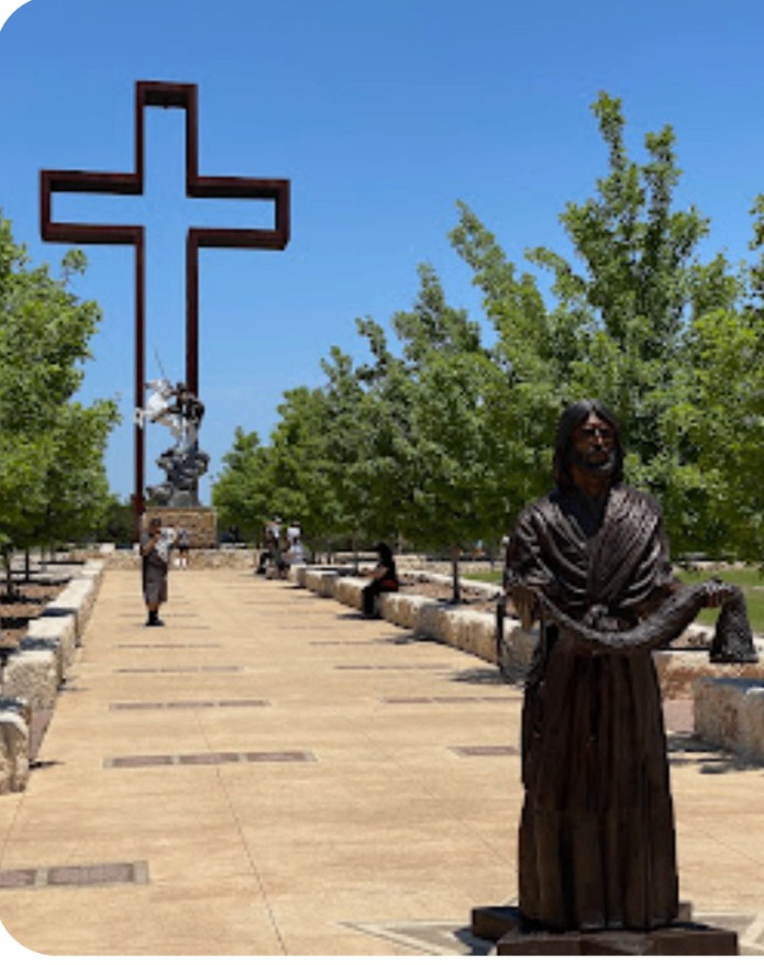 The Empty Cross and bronze sculptures at The Coming King Sculpture Prayer Garden in Kerrville, Texas